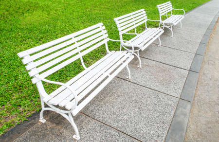 A white chair in a green gardenの写真素材