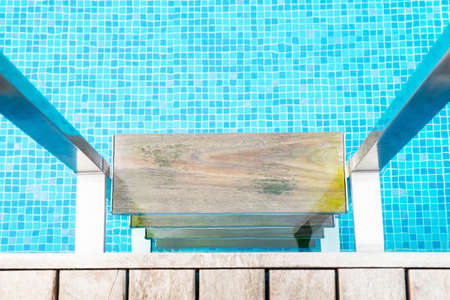 Swimming pool with close up wooden stair close upの写真素材
