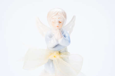 ceramic doll of a little girl prayingの写真素材