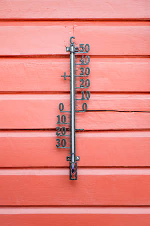 Classic Thermometer  on a wooden background.の写真素材