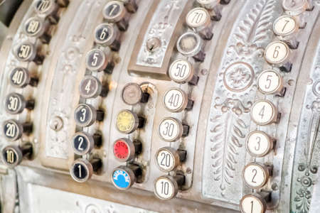 Old-time cash register in a shop. Isolated on white background.の写真素材