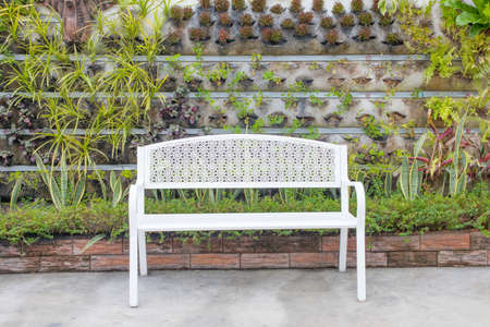 A white chair in a green gardenの写真素材