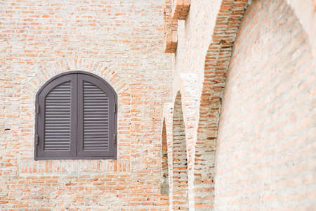 Brown wooden window on brick wallの写真素材