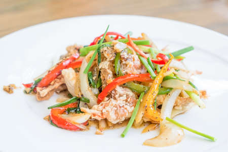Chili fried crab with black peper on wooden table