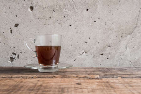 warm cup of coffee wite cement backgroundの写真素材