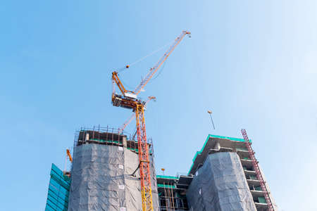 Big yellow crane in constuction siteの写真素材