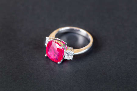 Closeup of diamind ring with ruby gem on black backgroundの写真素材