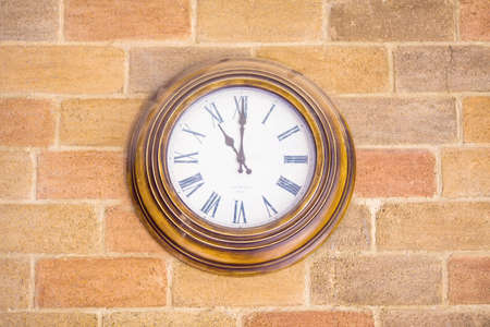 vintage wall clock on white brick wallの写真素材