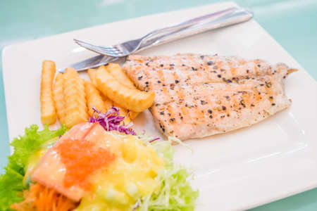 salmon steak with fried and saladの写真素材