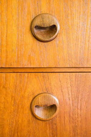 closeup vintage wooden handle on old brown wood drawerの写真素材