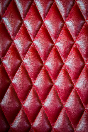 Closeup texture of vintage red leather sofa for backgroundの写真素材