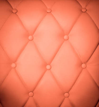 Closeup texture of vintage red leather sofa for backgroundの写真素材