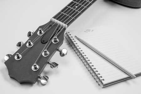 Notebook and pencil on guitar,Writing musicの写真素材