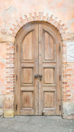 Old Wooden Door on Grunge Brick Wallの写真素材