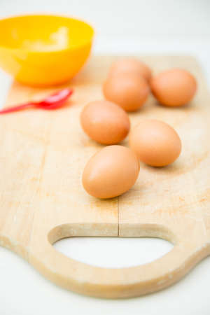 eggs in the on wooden cutting board prepare for cookingの写真素材