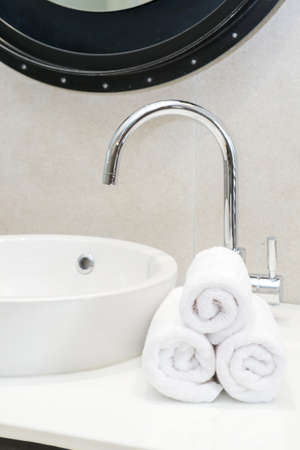 Stacked white spa towels in bathroomの写真素材