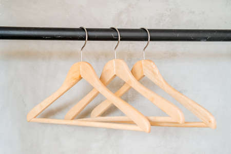 Coat hangers on clothes railの写真素材