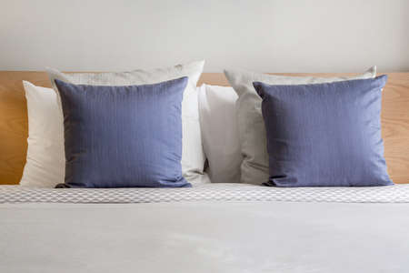 stylish bedroom interior design with colorful pillows on bedの写真素材