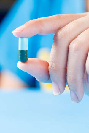 Closeup shot of a Female hand holding acapsule pillの写真素材