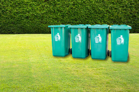 Row of Green plastic dust recycling bin in garden