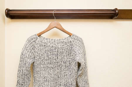 female coat clothes hanging on clothes rackの写真素材