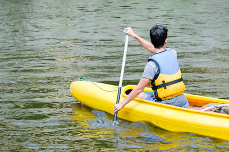Outdoor shot of man canoeing in the lakeの写真素材