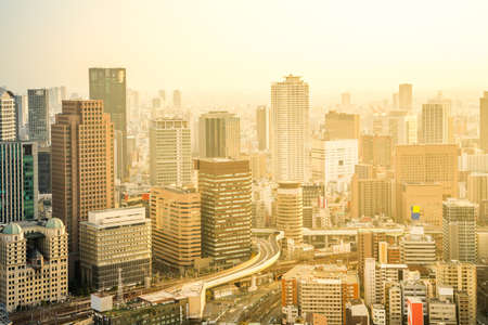 Business concept for real estate and corporate construction - panoramic modern city skyline bird eye aerial view with dramatic sunrise and morning sky in Osaka, Japanのeditorial素材