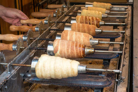 Traditional street food of country Czech Republic. Preparing of Trdelnikの写真素材