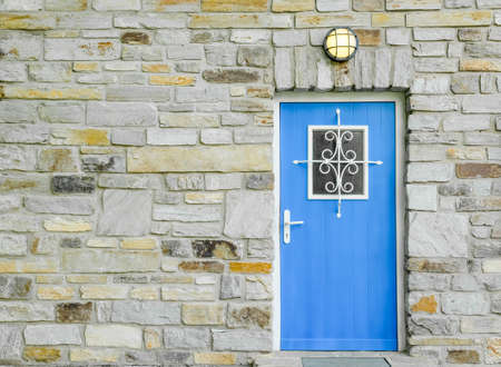 brick wall with wooden blue doorの写真素材