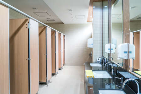 Modern clean toilet decorated with tiles with sinksの写真素材