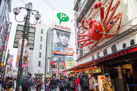 OSAKA, JAPAN - JAN 15 2016: Crowds walk below the signs of Dotonbori area in Osaka, Japan.のeditorial素材