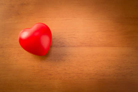 Two red heart shape on wooden background