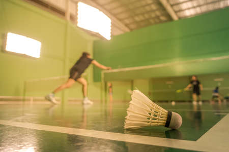 badminton courts with players competingの写真素材
