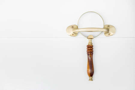 vintage magnifying lens hanging on the wallの写真素材