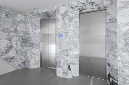 Front view of a mable elevator with closed doors in buildingの写真素材