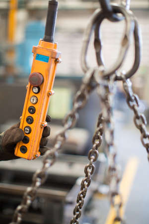 Hand pressing up and down switch in factoryの写真素材