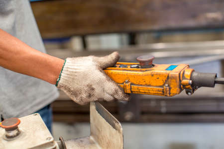 Hand pressing up and down switch in factoryの写真素材