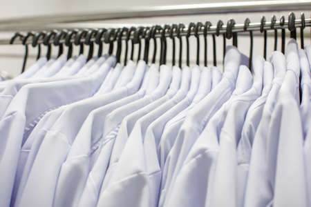 Doctor shirts hanging on rackの写真素材