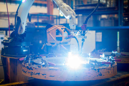 Welding robots movement in factory close upの写真素材