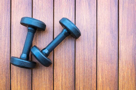 two dumbbells on wooden backgroundの写真素材