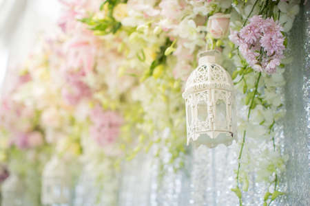 Decoration made of lamps with flower on backdrop for wedding partyの写真素材