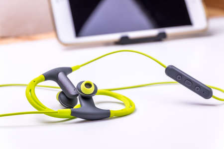 Wireless headphones on a white tableの写真素材