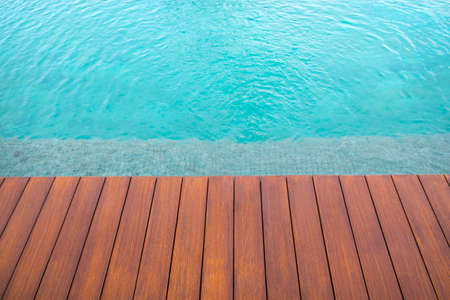 Beautiful luxury swimming pool at hotel resort with wooden backgroundの写真素材