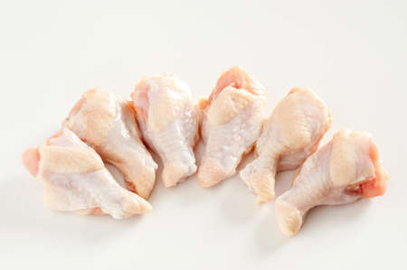 raw chicken legs on white packagingの写真素材