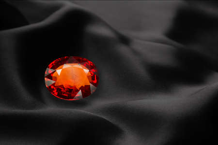 red sapphire on black background luxury cloth or liquid wave or wavy folds of grunge silk textureの写真素材