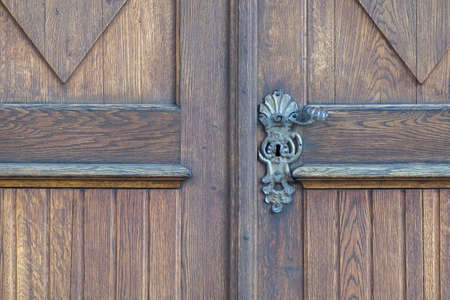 metal door handle and brown wood doorの写真素材