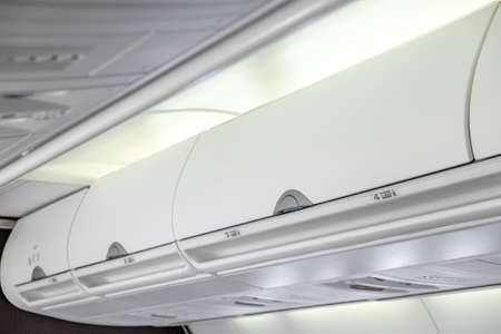 Overhead compartment - detail shot of an airplane cabin interiorの写真素材