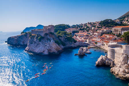 Old Town houses with red tiled roofs and rocky green idyllic island in background, Dubrovnik, Dalmatia, Croatiaのeditorial素材