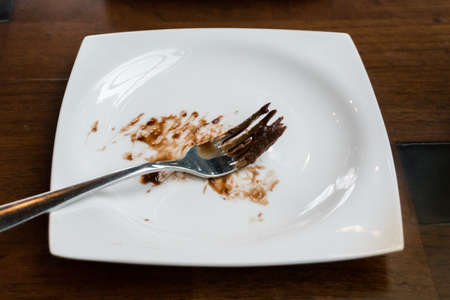 Dirty and empty dishes on wooden table.の写真素材