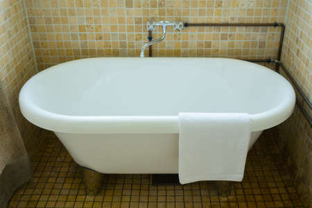 Towel on classic bathroom with old bathtubの写真素材